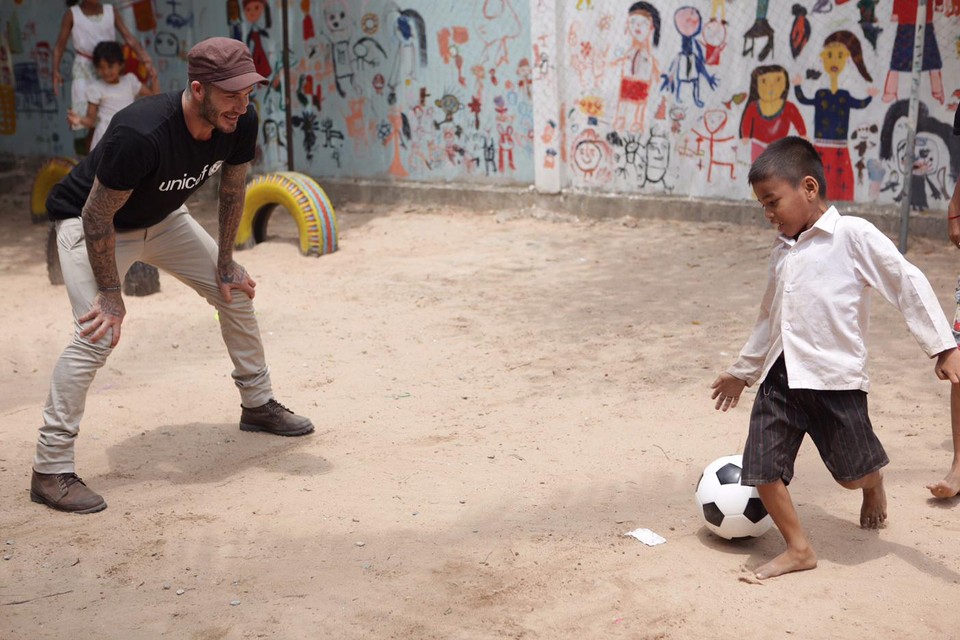 Unicef-ambassadeur David Beckham voetbalt met kinderen in Cambodja. 
