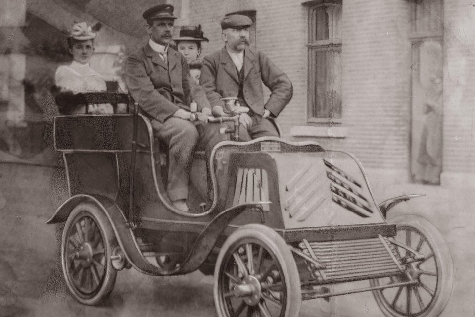 Foto uit 1898 of 1899 van de bouwers van de eerste Konings-auto. Met achter het stuur Ferdinand Anderheggen, ontwerper van de transmissie, rechts Peter Konings en achterin zijn drie dochters. 