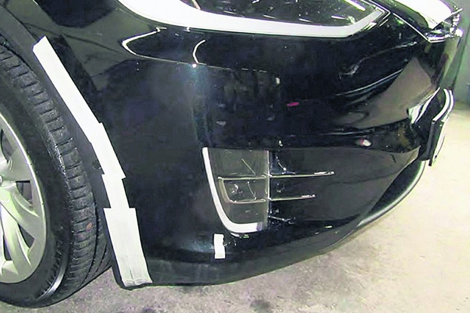 Met tape gerepareerde schade aan de verhuurde Tesla.