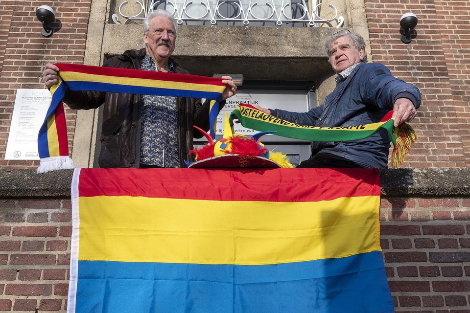 Peter Hoop (l) en Jacques Könings, met de rood-geel-blauwe carnavalsvlag van Munstergeleen.  