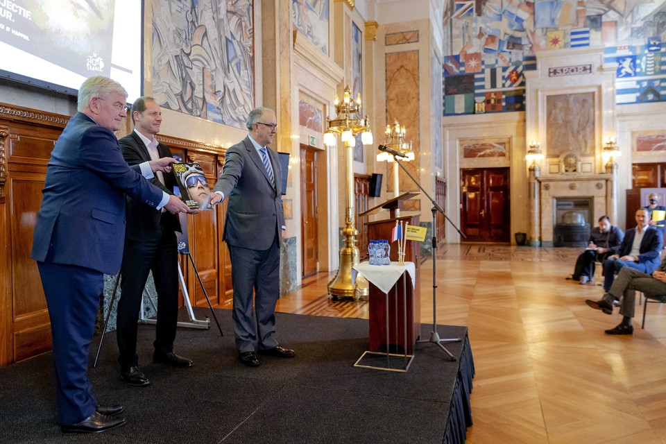 De burgemeesters Jan van Zanen (links) en Ahmed Aboutaleb van Den Haag en Rotterdam overhandigen het bidbook aan Tourdirecteur Christian Prudhomme.  