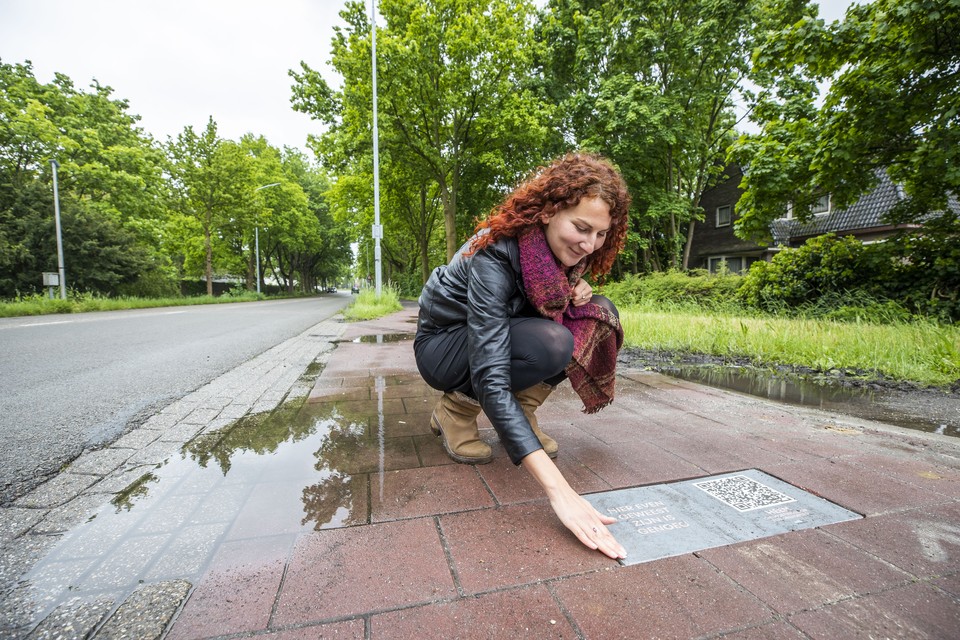 Theater- en documentairemaakster Naomi Steijger bij één van de vijf stoeptegels van de audiowandeling op de Kaldenkerkerweg. 